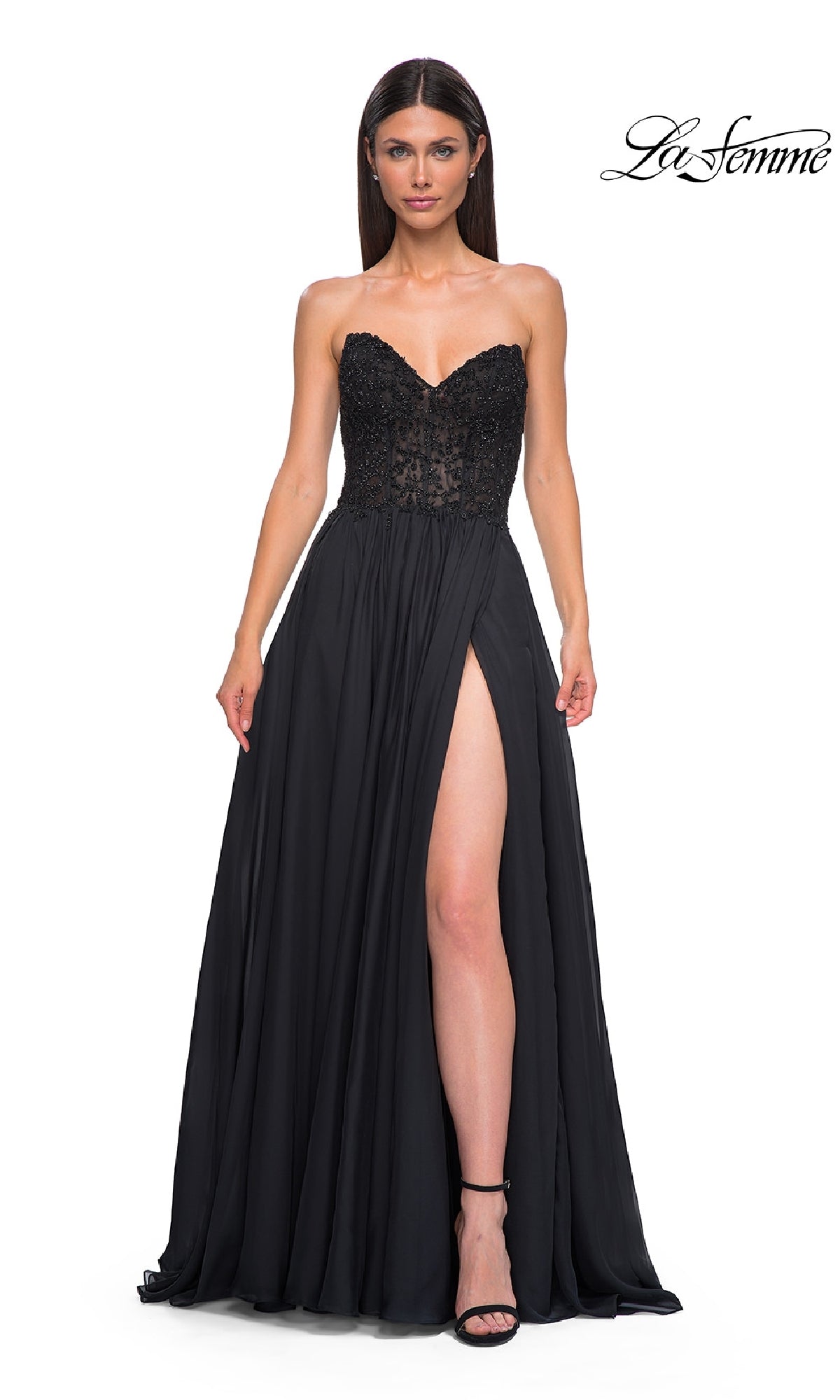 A woman stands with one leg forward against a white background, wearing the La Femme 32804: a strapless long A-line prom dress featuring a lace bodice and high slit.
